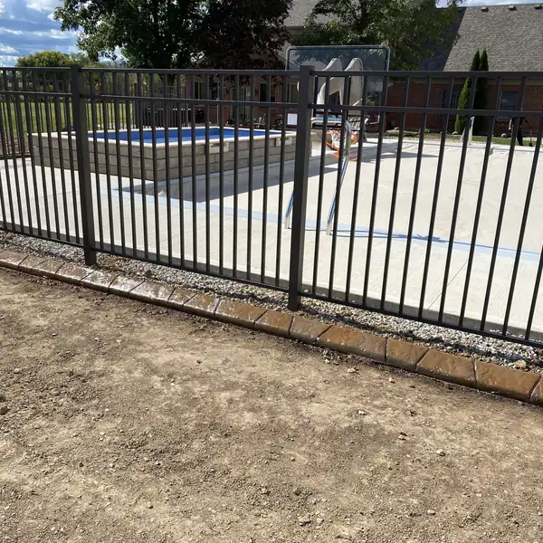 Concrete curb following a pool fence line